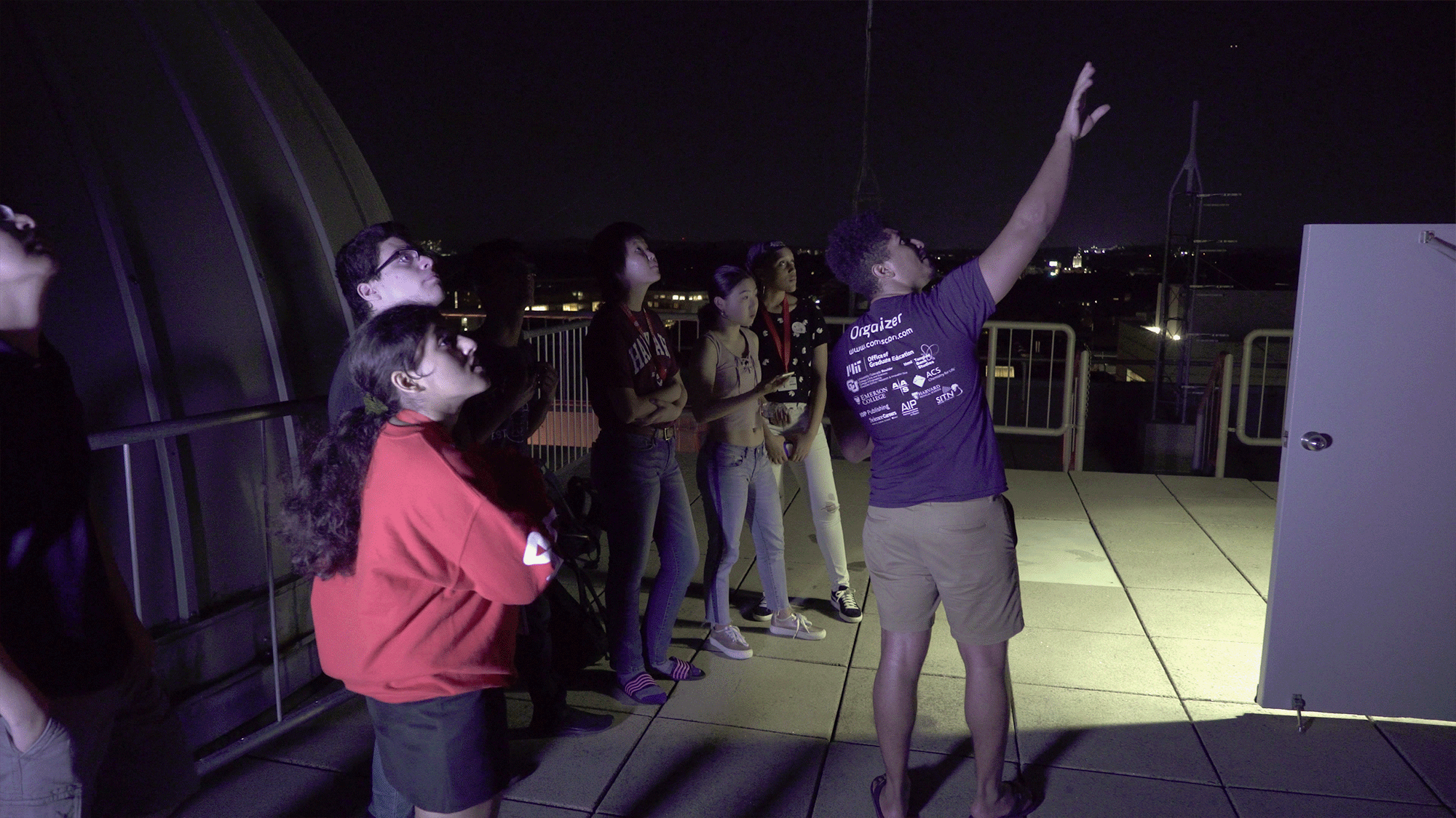 Students watch the night sky during an astronomy lesson.