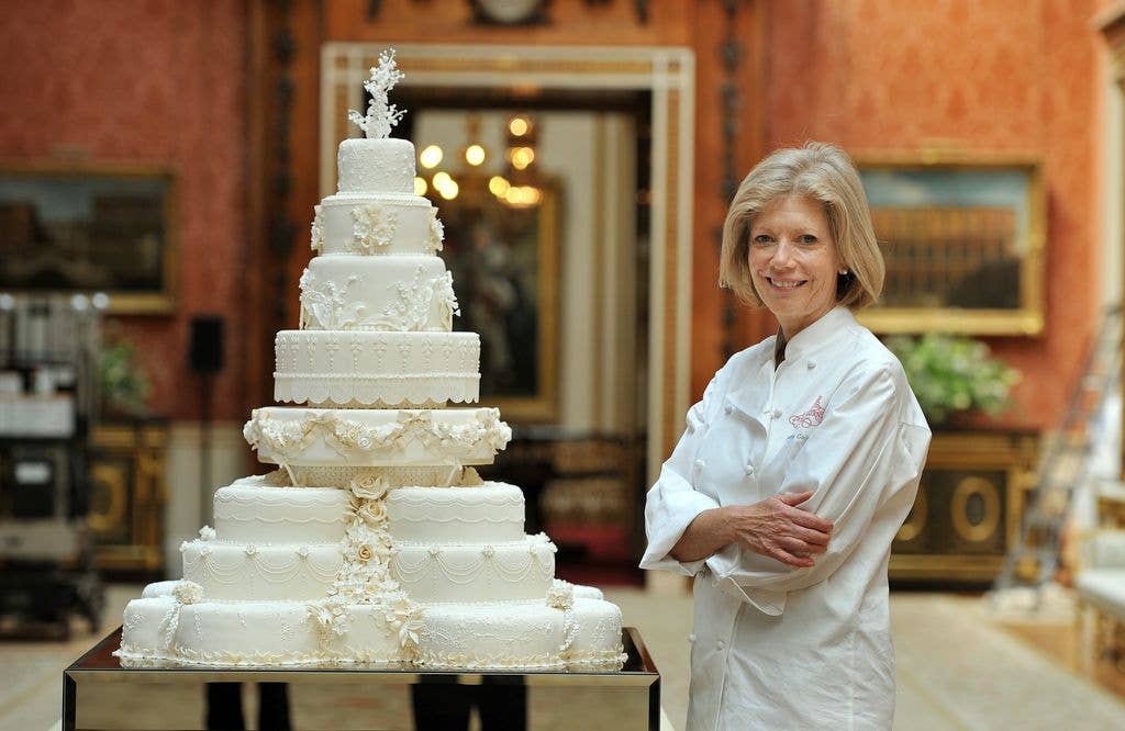 Fiona Cairns stands next to the Royal Wedding cake