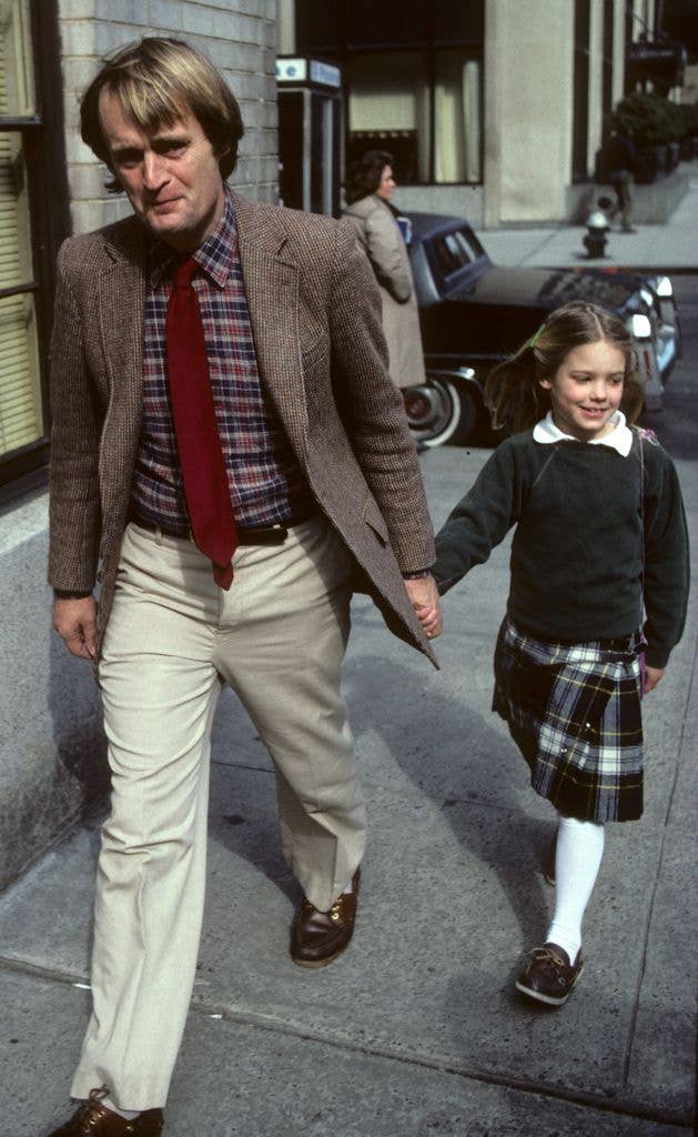 David McCallum holds daughter Sophie's hand as they walk down a pavement.