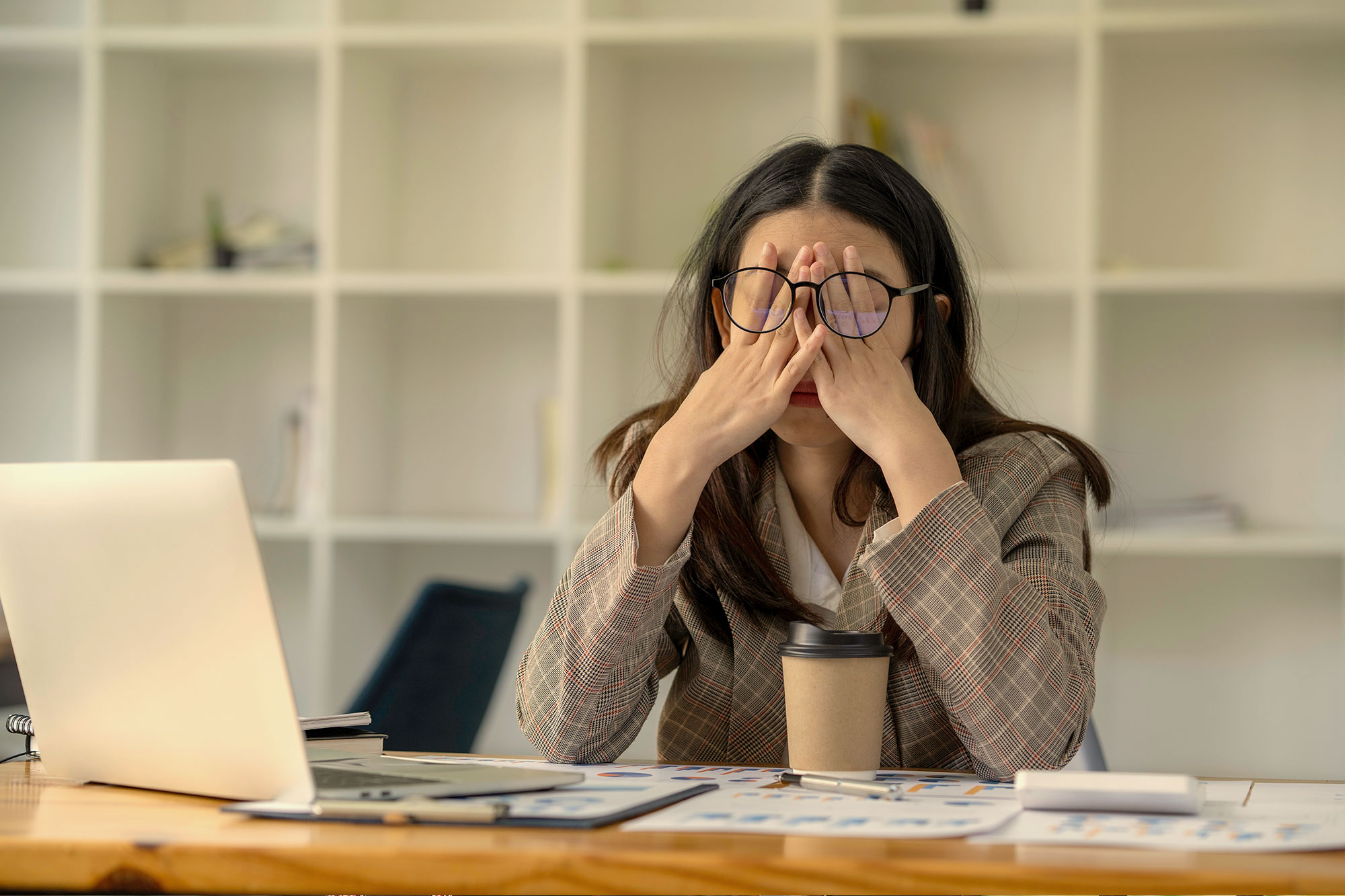 Stressed person sitting at a desk.