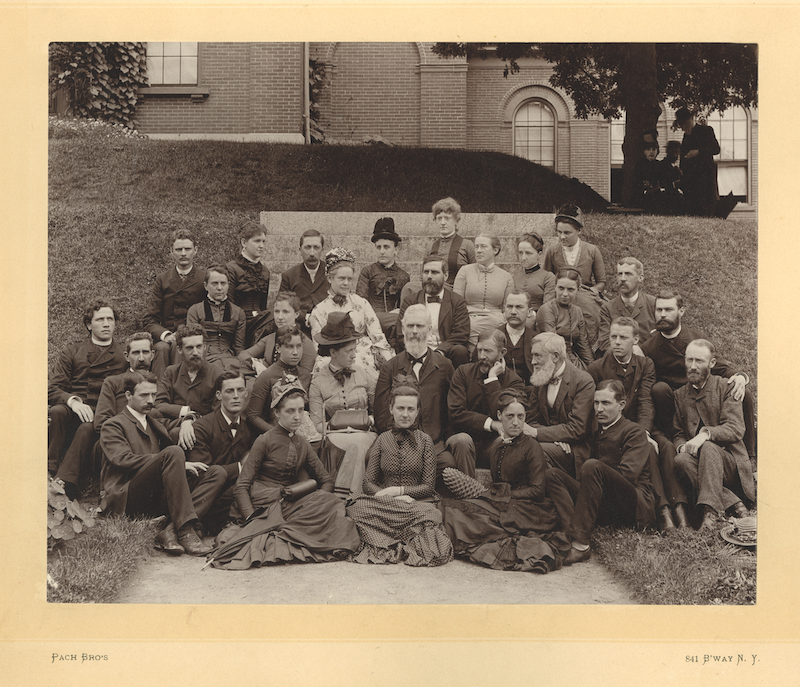 A sepia photograph of Asa Gray surrounded by his student from the Harvard Summer School. Taken in 1886.